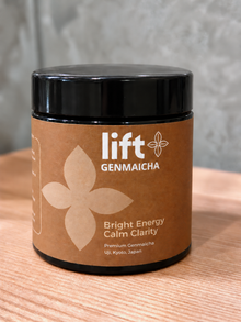 Lift Genmaicha black jar with a brown label on a wooden tabletop